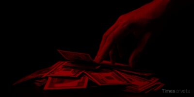 Hand reaching for money in darkness